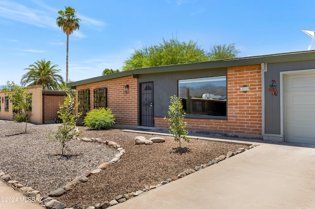 ranch-style home featuring a garage