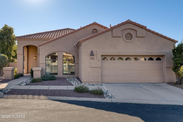 mediterranean / spanish-style house featuring a garage