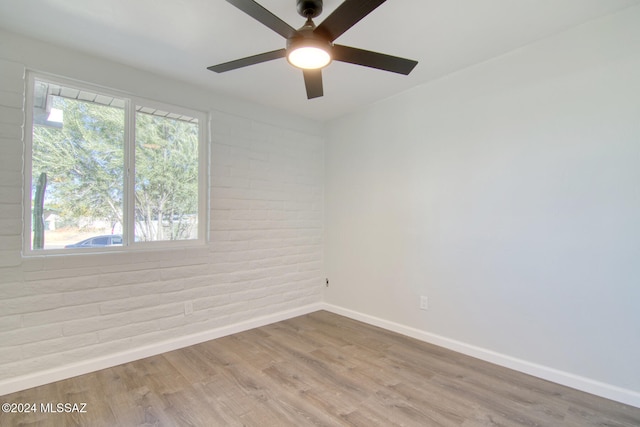 empty room featuring ceiling fan and light hardwood / wood-style flooring