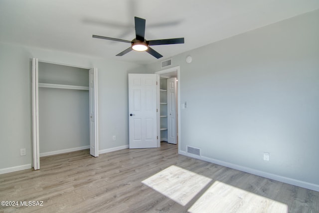 unfurnished bedroom with ceiling fan and light wood-type flooring