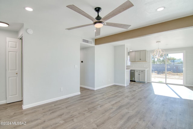 unfurnished living room featuring light hardwood / wood-style floors and ceiling fan with notable chandelier