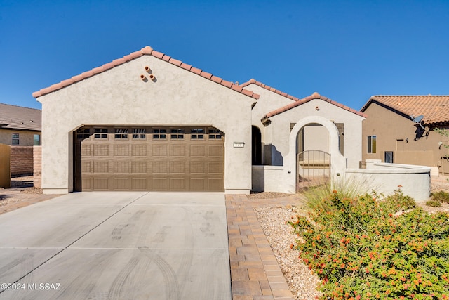 mediterranean / spanish home featuring a garage