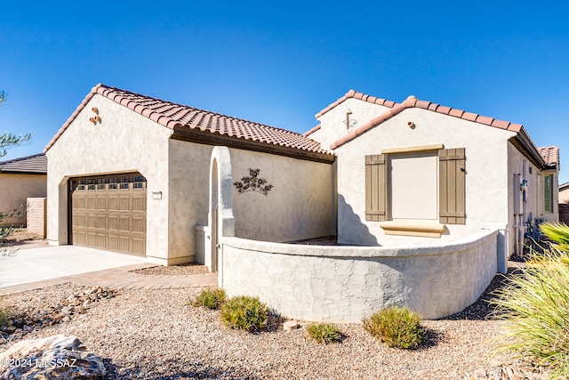 mediterranean / spanish-style home with a garage