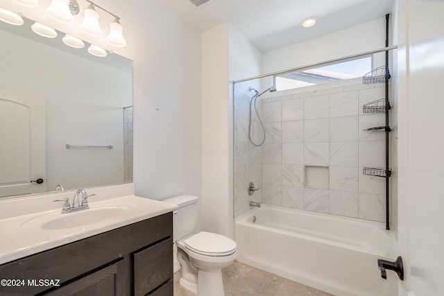 full bathroom featuring vanity, tile patterned flooring, tiled shower / bath, and toilet