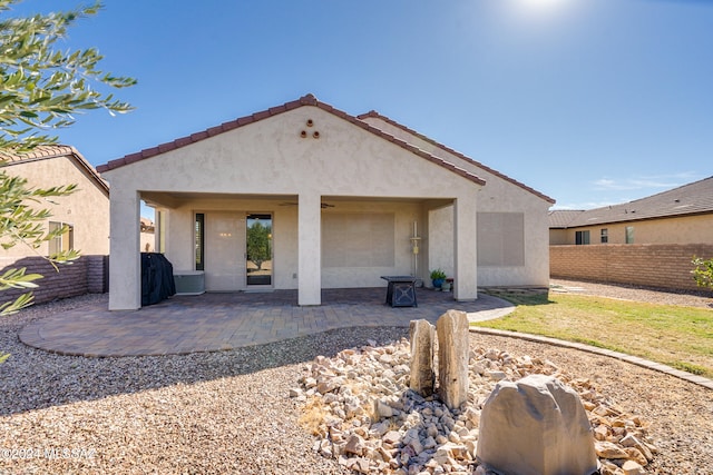 back of property with a patio