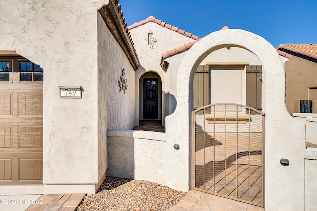 view of exterior entry with a garage