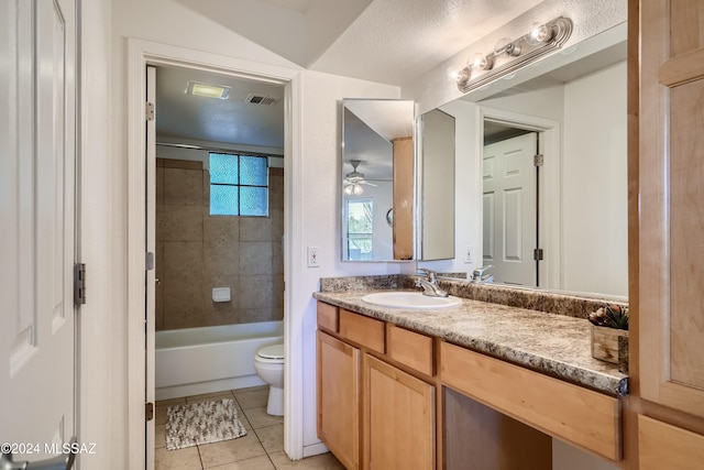 full bathroom featuring tile patterned flooring, ceiling fan, vanity, toilet, and tiled shower / bath combo