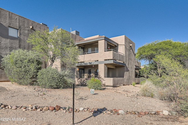 back of property featuring a balcony