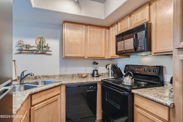 kitchen with black appliances, light brown cabinetry, sink, and light stone countertops