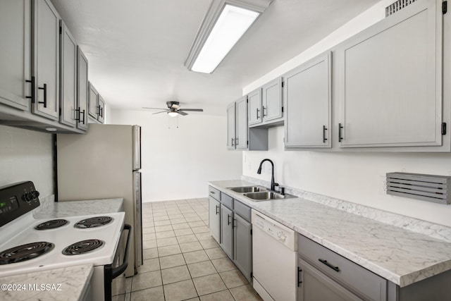 kitchen with white appliances, sink, ceiling fan, gray cabinets, and light tile patterned floors