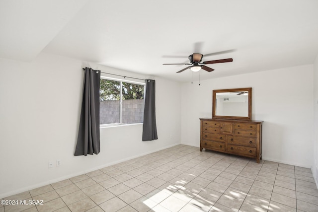 tiled spare room featuring ceiling fan