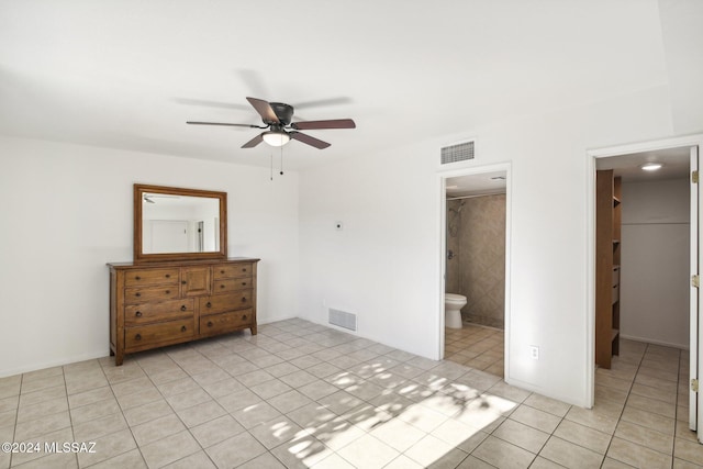 unfurnished bedroom featuring ceiling fan, light tile patterned floors, and connected bathroom