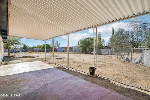 view of patio featuring a storage shed