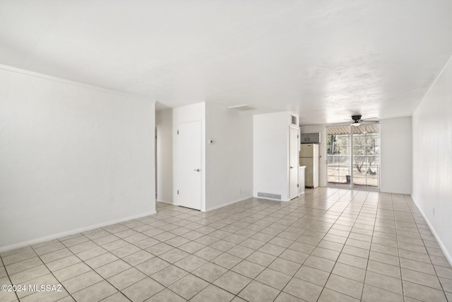 empty room featuring ceiling fan and light tile patterned floors