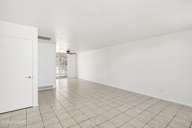 empty room with ceiling fan and light tile patterned floors