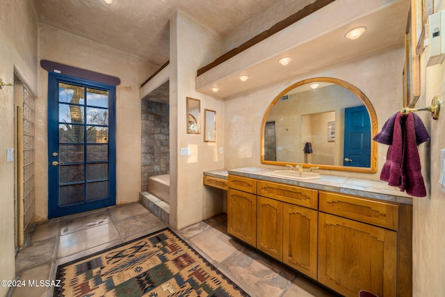 bathroom with vanity and a washtub