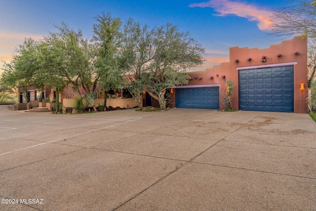 pueblo-style home with a garage