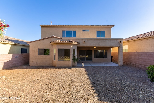 back of property featuring a patio area