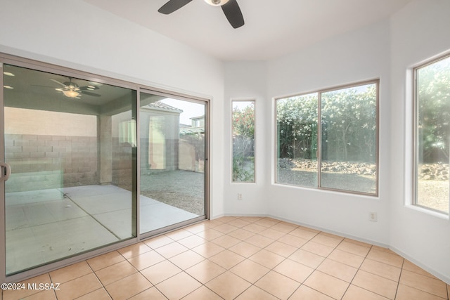 unfurnished sunroom with ceiling fan