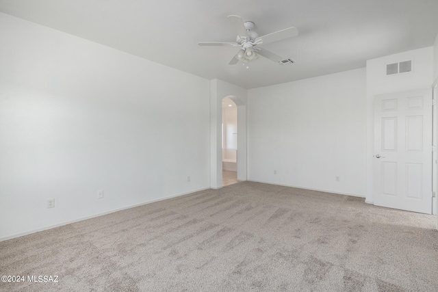 carpeted spare room with ceiling fan