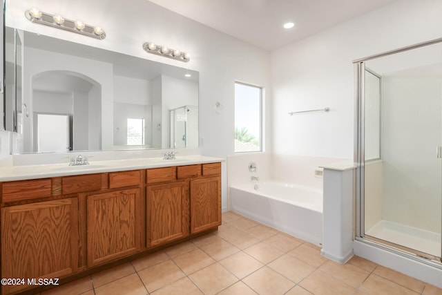 bathroom featuring shower with separate bathtub, tile patterned floors, and vanity