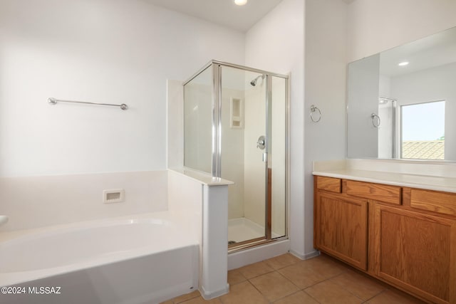 bathroom featuring vanity, tile patterned flooring, and separate shower and tub