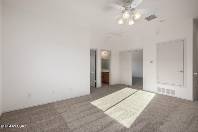 unfurnished bedroom featuring ceiling fan, ensuite bath, light carpet, and a closet