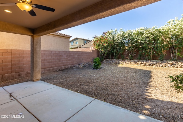 view of yard featuring ceiling fan and a patio