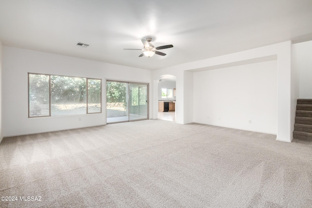 unfurnished living room with ceiling fan and carpet floors