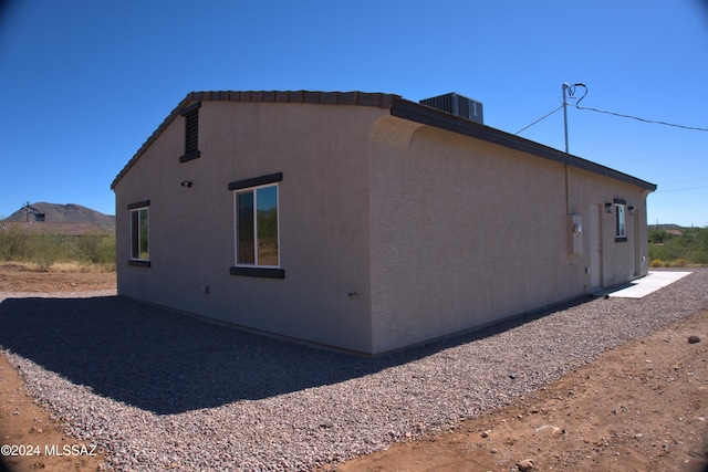 view of side of property with central AC