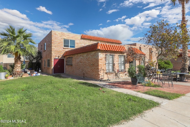 view of home's exterior featuring a lawn and a patio area