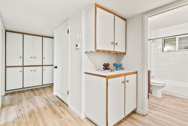 corridor with light hardwood / wood-style flooring