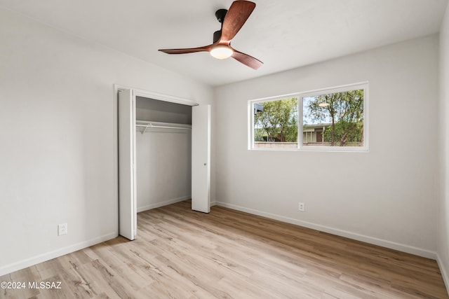 unfurnished bedroom with light hardwood / wood-style floors, ceiling fan, and a closet