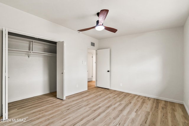 unfurnished bedroom with light hardwood / wood-style floors, ceiling fan, and a closet