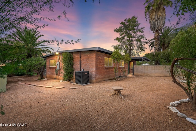 property exterior at dusk with central AC unit