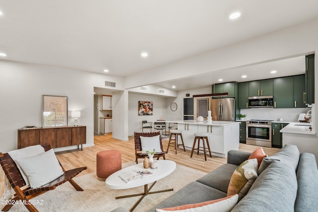 living room featuring light wood-type flooring and sink