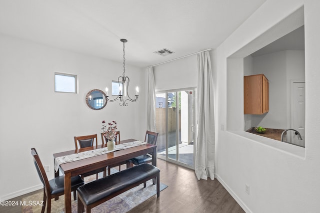 dining area featuring baseboards, dark wood finished floors, visible vents, and a healthy amount of sunlight