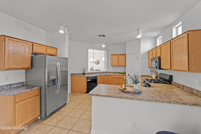 kitchen featuring light tile patterned floors, visible vents, a peninsula, black appliances, and a sink