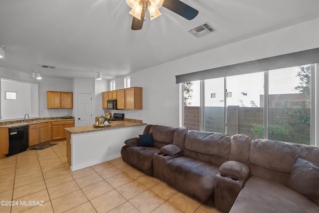 living area featuring light tile patterned floors, visible vents, and a ceiling fan