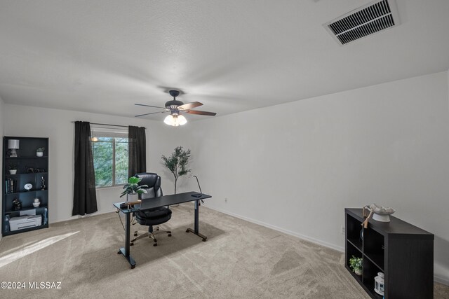 office space with ceiling fan, carpet flooring, visible vents, and baseboards