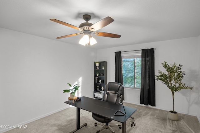 carpeted home office featuring ceiling fan and baseboards