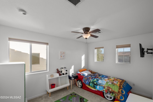 bedroom featuring a ceiling fan, baseboards, visible vents, and carpet flooring