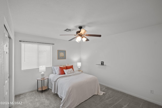 bedroom with carpet floors, visible vents, ceiling fan, and baseboards