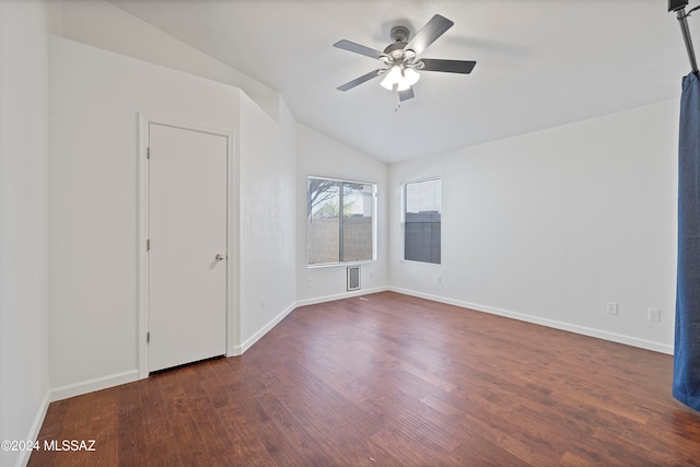 spare room featuring dark hardwood / wood-style flooring, lofted ceiling, and ceiling fan