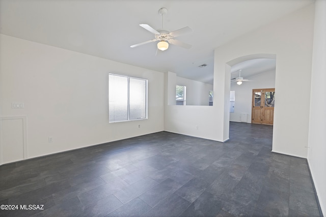 empty room featuring lofted ceiling and ceiling fan