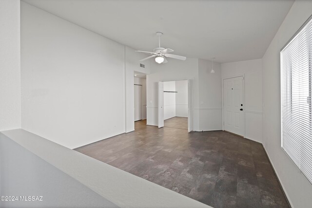 spare room featuring dark wood-type flooring and ceiling fan