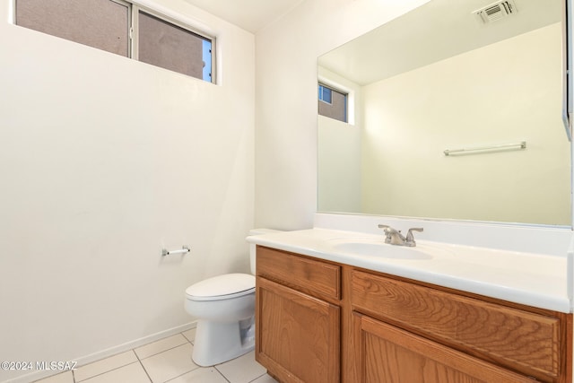 bathroom featuring vanity, tile patterned flooring, and toilet