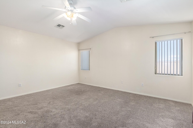 unfurnished room featuring ceiling fan, vaulted ceiling, and carpet