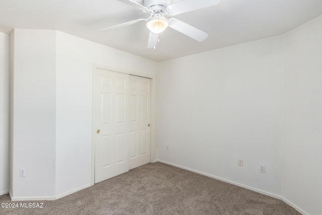 unfurnished bedroom featuring a closet, carpet, and ceiling fan