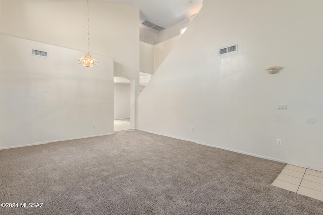 empty room with carpet flooring and a high ceiling